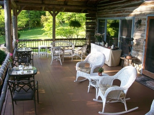 whicker rockers and black patio tables on porch