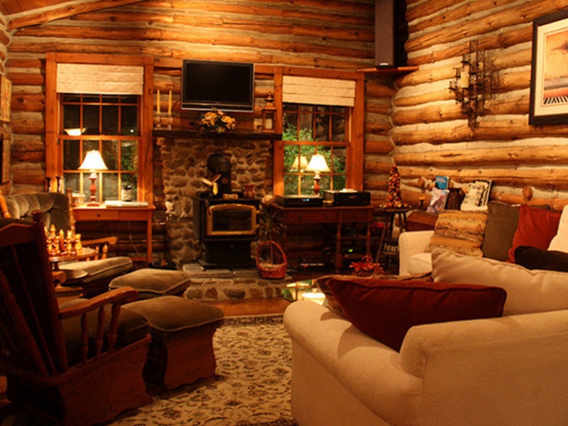 log cabin living room with wood burning stove