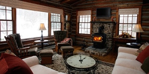 log cabin living room with wood burning stove
